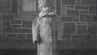 Hugh Miller as a boy in a Shropshire sheep coat, standing in front of the Thistle Ha' homestead in what is now Pickering, Ontario.